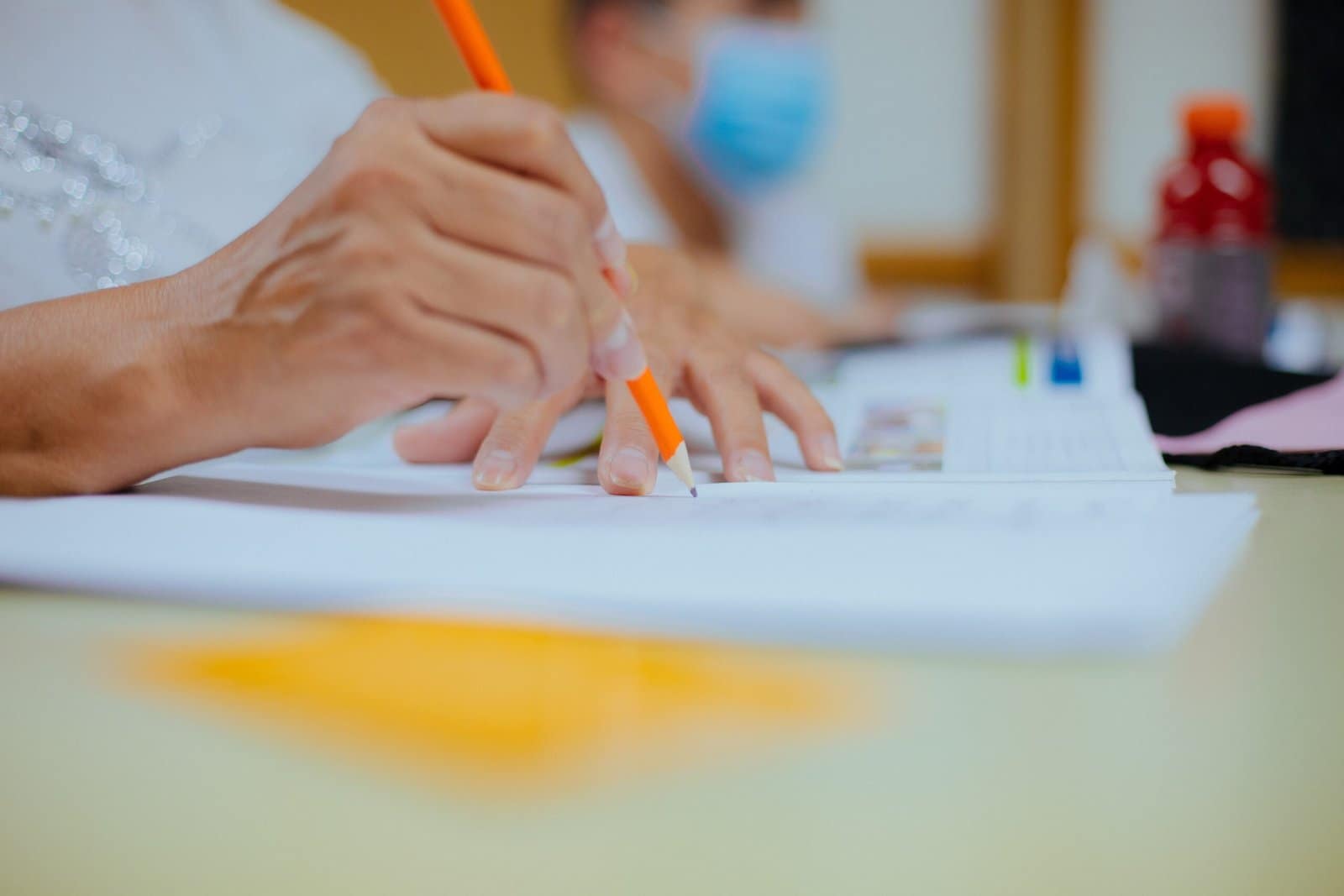 Hands writing using a pencil